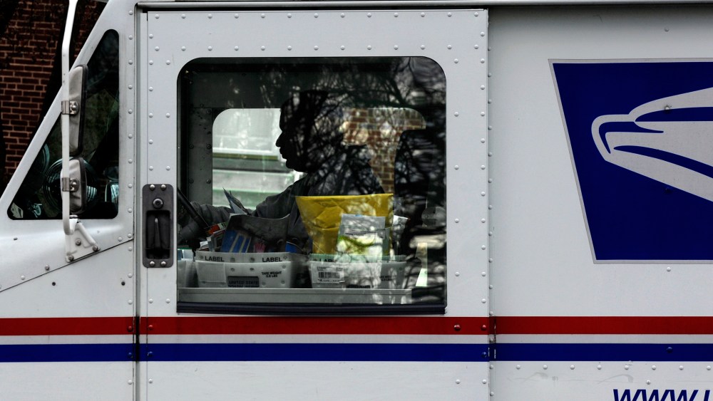 Postal carrier Anthony White sits in his truck while making his rounds in Kensington, Md. on Feb. 6, 2013.
