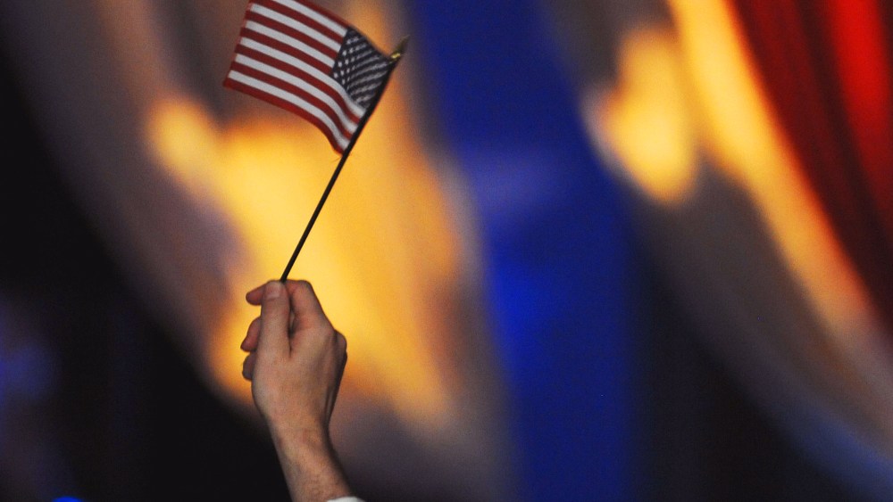 (HR) A member in the crowd holds up an American flag. The featured entertainment at the The Western Ball at the Convention Center was Salsa singer Marc Anthony and his wife singer/actress Jennifer Lopez. Anthony sang with his large band of 15 members and