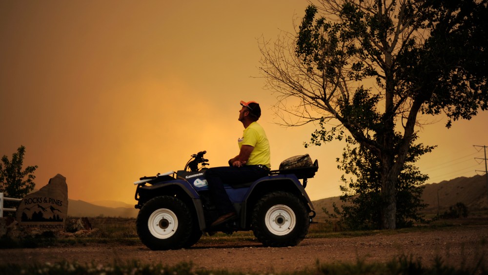 Lon Boehmer watches as the High Park fire burns west of Fort Collins and Loveland on June 10, 2012.