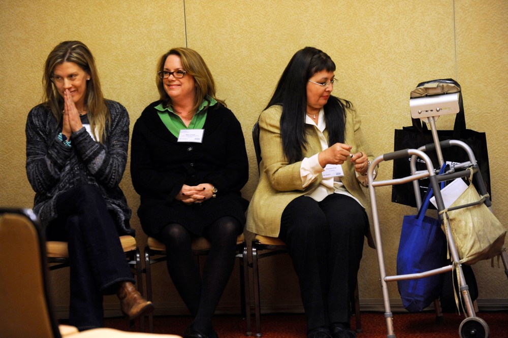 Annie Freedom, left, owner of Samadhi Center for Yoga, gives a namaste salutation after giving her two-minute pitch for her business.