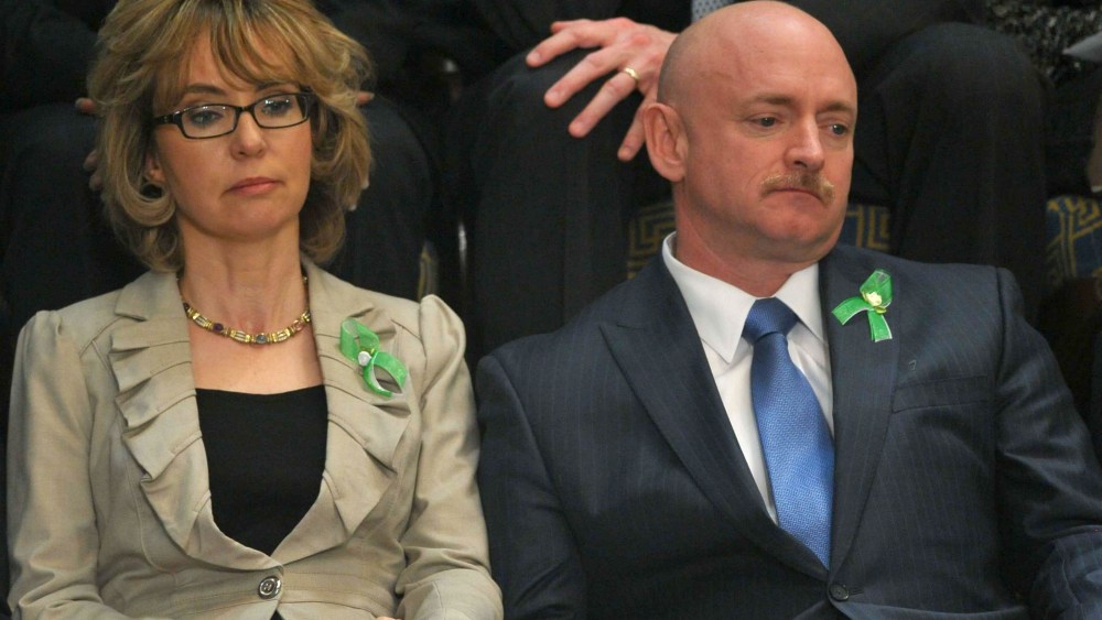 Former US Representative Gabrielle Giffords and her husband former astronaut Mark Kelly listen to US President Barack Obama deliver his State of the Union address before a joint session of Congress on February 12, 2013 at the US Capitol in Washington. ...