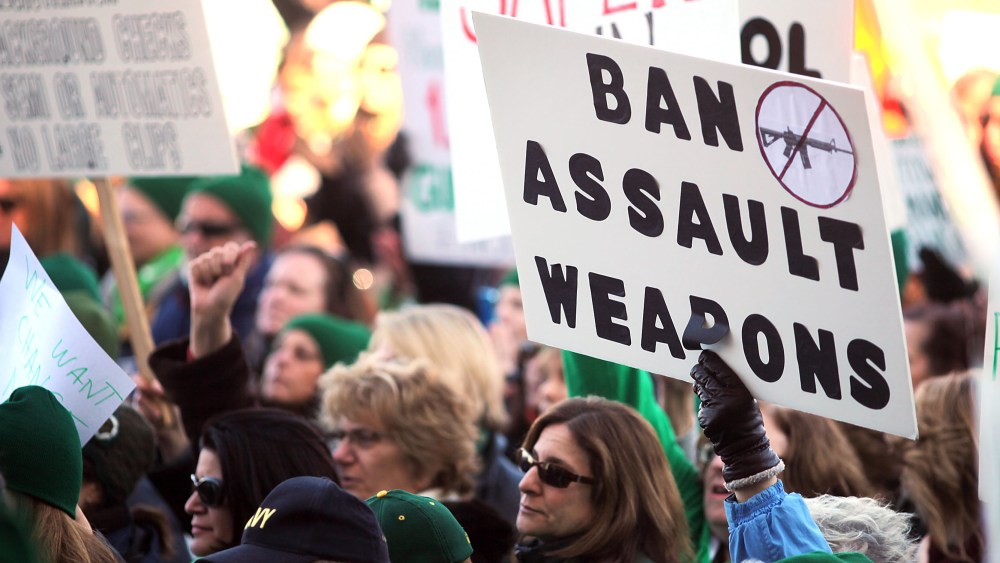 People hold signs during a rally at the Connecticut State Capital to promote gun control legislation in the wake of the December 14, 2012, school shooting in Newtown on February 14, 2013 in Hartford, Connecticut. Referred to as the "March for Change"...