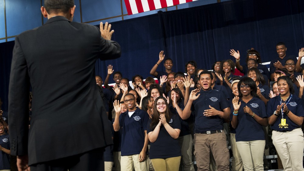 Barack Obama waves to students prior to speaking at Hyde Park Academy in Chicago, Feb. 15, 2013.
