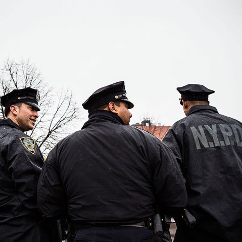New York Police Department officers monitor a march against stop-and-frisk tactics used by police on February 23, 2013 in New York City.  (Photo by Andrew Burton/Getty)