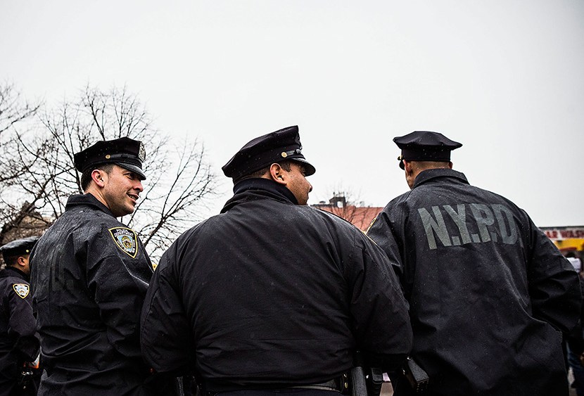 New York Police Department officers monitor a march against stop-and-frisk tactics used by police on February 23, 2013 in New York City.  (Photo by Andrew Burton/Getty)