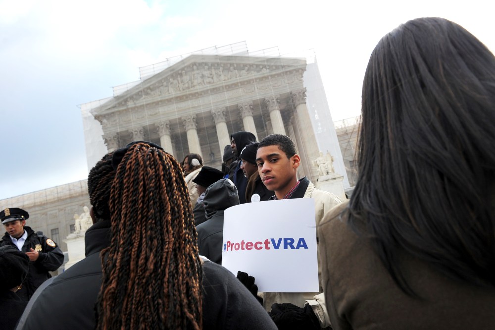 An activist holds a pro-voting rights placards outside of the US Supreme Court in Washington, DC, Feb. 27, 2013.
