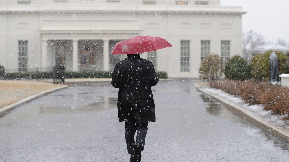 A White House staffer walks to the West Wing during a snow storm at the White House March 6, 2013 in Washington, DC. The snow forced all major school systems in the area to close, including today's White House press briefing.  (Photo by Olivier...