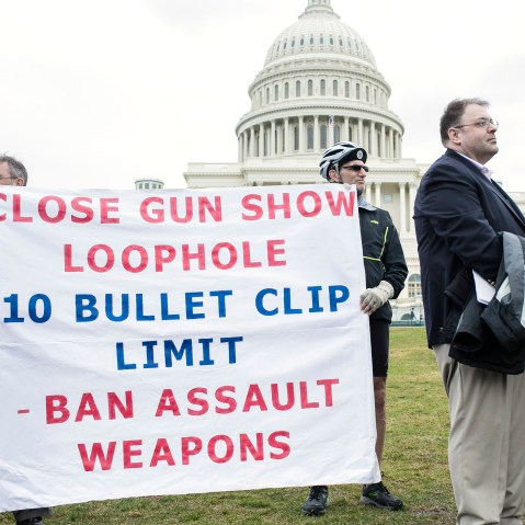 File Photo: Supporters with a group of 26 cyclists who rode from Newtown, Connecticut in support of common-sense solutions to gun violence hold up banners during a press conference with congress members from Connecticut on March 12, 2013 in Washington,...