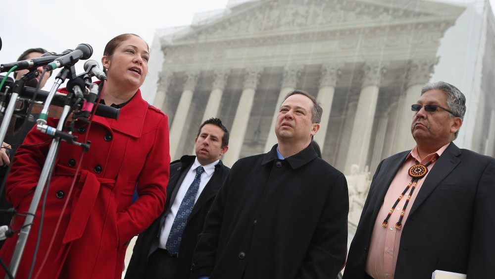 Mexican American Legal Defense and Education Fund Director of Litigation Nina Perales, MALDEF lawyer Luis Figaroa, Georgetown University law professor Jon Greenbaum and San Carlos Apache Tribal Chairman Terry Rambler talk with reporters outside the U.S...