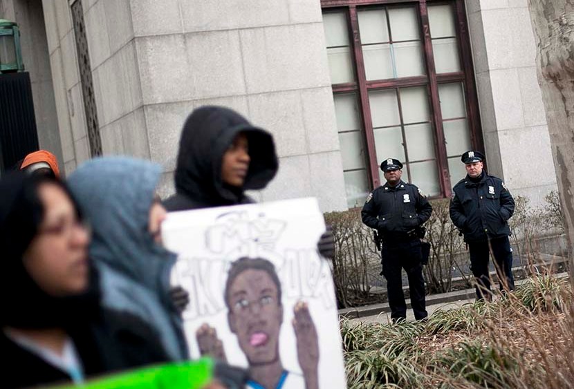 New York City Police officers watch over a demonstration against the city's "stop and frisk" searches in lower Manhattan near Federal Court March 18, 2013 in New York City. (Photo by Allison Joyce/Getty)