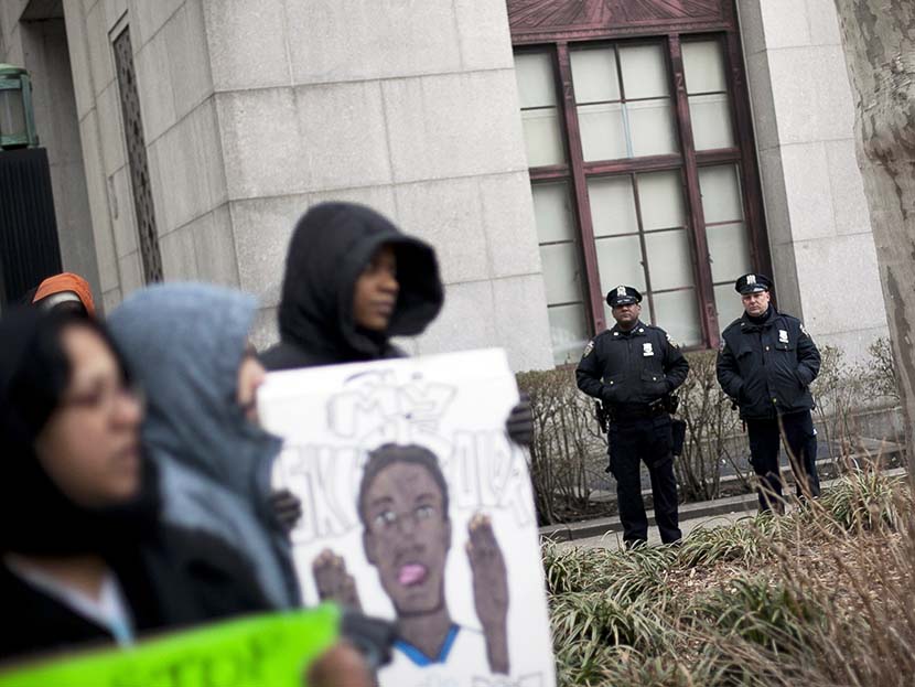 New York City Police officers watch over a demonstration against the city's "stop and frisk" searches in lower Manhattan near Federal Court March 18, 2013 in New York City. (Photo by Allison Joyce/Getty)