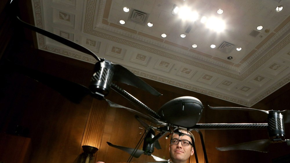 Mesa County Sheriff's Office Unmanned Aircraft Program Manager Benjamin Miller testifies before the Senate Judiciary Committee while framed by a Draganflyer X6 remote-controlled  miniature helicopter in the Dirksen Senate Office Building on Capitol...