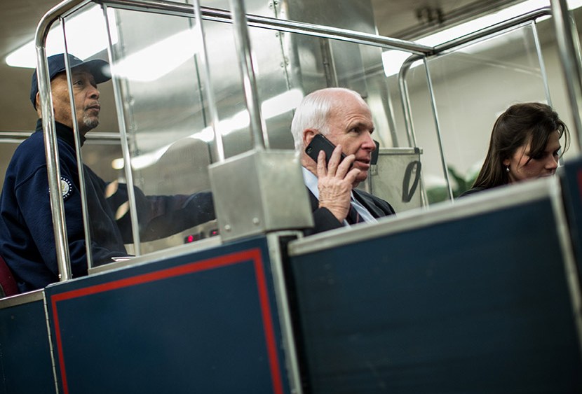 U.S. Sen. John McCain (R-AZ) (C) rides the Senate subway prior to votes on Capitol Hill March 22, 2013 in Washington, DC.  (Photo by Drew Angerer/Getty Images)