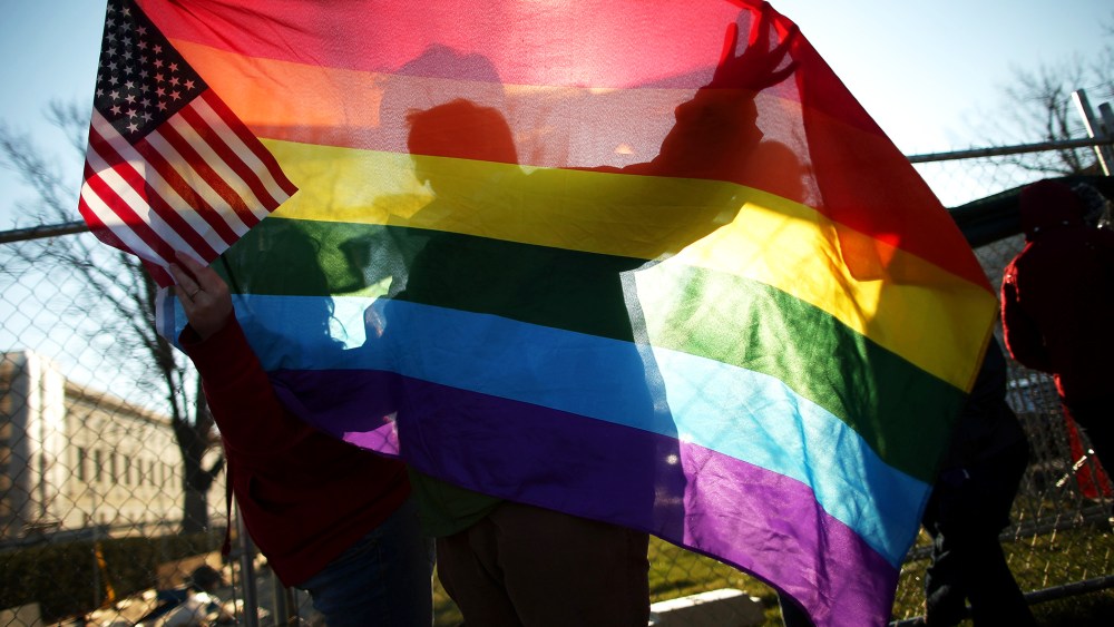 Heather Davidson and Julie Berger, both of Shelbyville, Indiana, join hundreds of other people lining up outside the Supreme Court for a chance to hear oral arguments on same-sex marriage, Mar. 27, 2013.