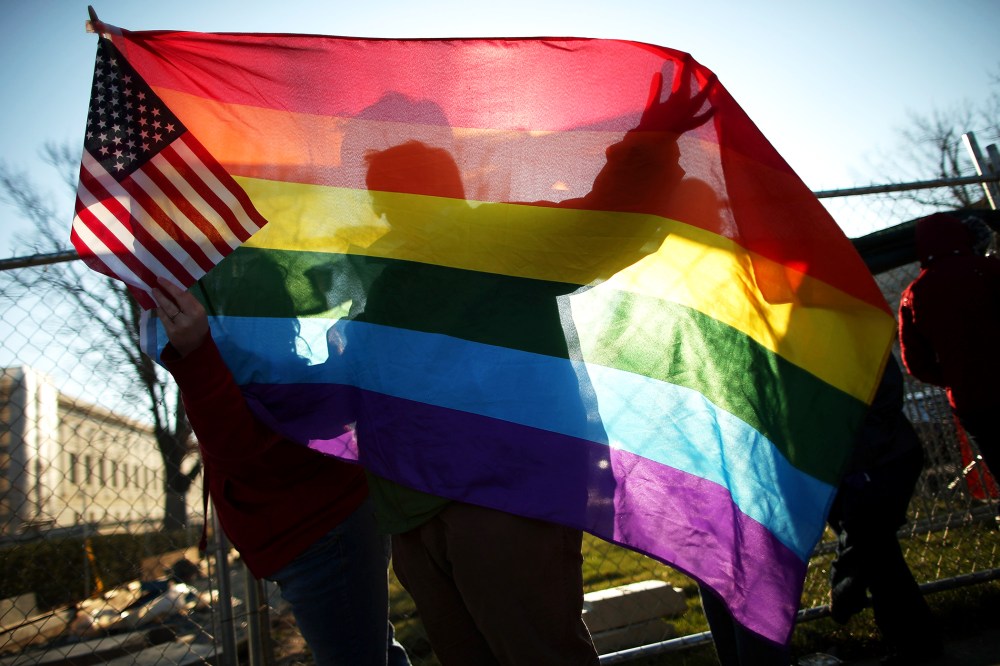 Heather Davidson and Julie Berger, both of Shelbyville, Indiana, join hundreds of other people lining up outside the Supreme Court for a chance to hear oral arguments on same-sex marriage, Mar. 27, 2013.