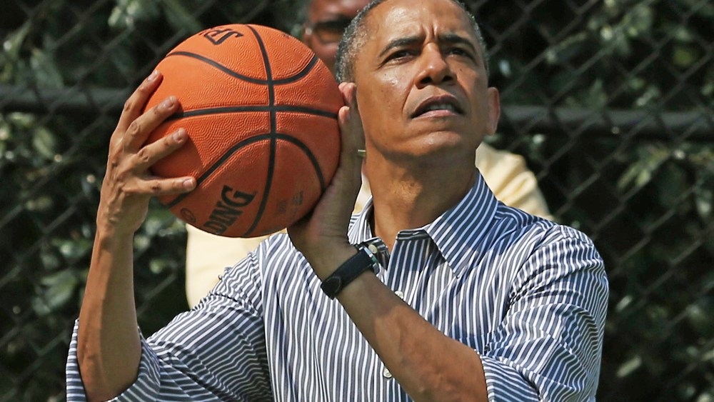 U.S. President Barack Obama plays basketball during the annual Easter Egg Roll on the White House tennis court April 1, 2013 in Washington, DC.