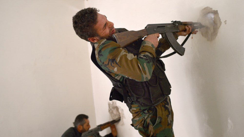 A Syrian rebel fires towards a position held by regime forces in the old city of Aleppo in northern Syria on April 6, 2013. Syrian President Bashar al-Assad has warned that the fall of his regime would destabilise the region "for many years", as US...
