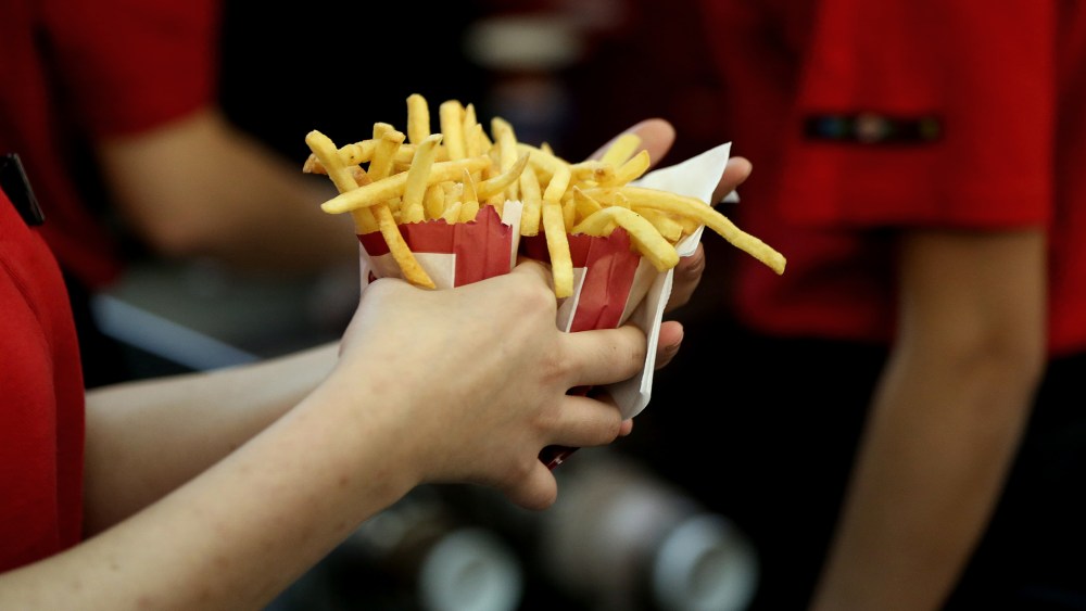 An employee collects two portions of french fries for a customer inside a Burger King restaurant. (Photo by Andrey Rudakov/Bloomberg/Getty)