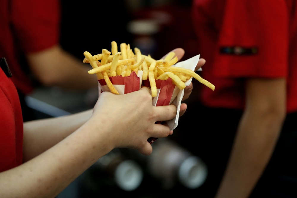 An employee collects two portions of french fries for a customer inside a Burger King restaurant. (Photo by Andrey Rudakov/Bloomberg/Getty)