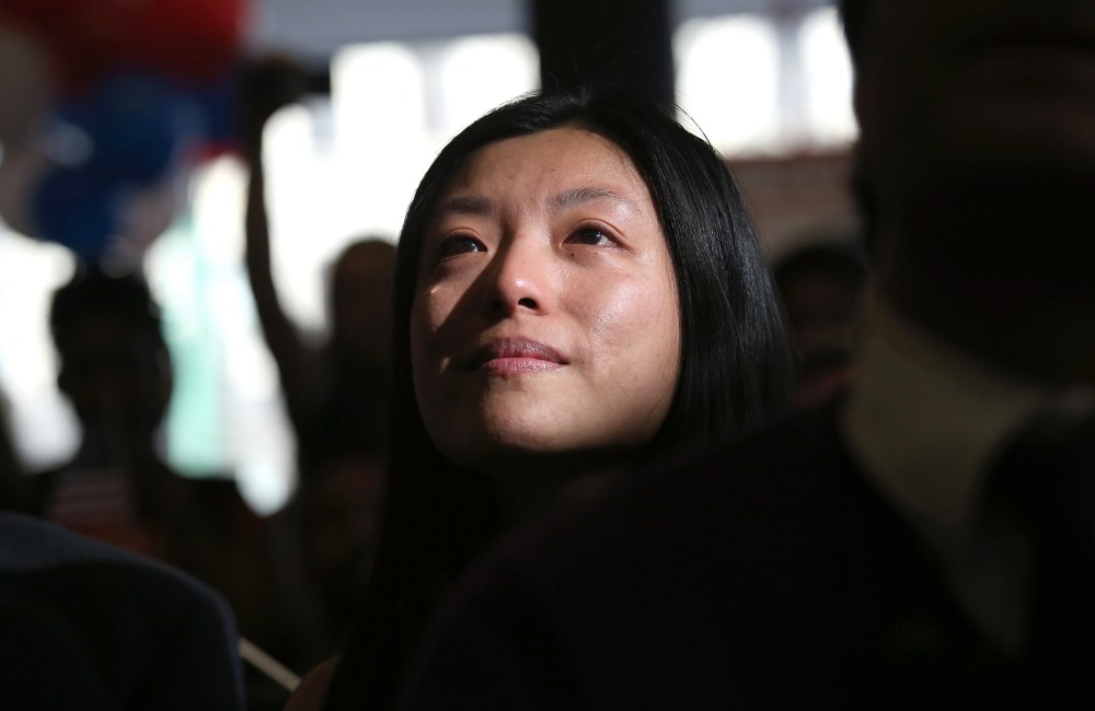 Chinese immigrant and new American citizen Yi Shu sheds a tear after taking the oath of citizenship at a naturalization ceremony on April 9, 2013 in New York City.