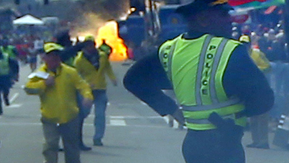 A second explosion goes off (rear) as a runner was blown to the ground by the first explosion near the finish line of the 117th Boston Marathon. (Photo by John Tlumacki/The Boston Globe via Getty Images)