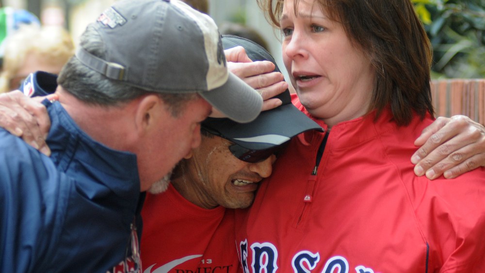 Runner John Ounao crying when he finds friends after several explosions rocked the finish of the Boston Marathon in Boston, Massachusetts, on April 15, 2013. (Photo by John Mottern/AFP/Getty Images)