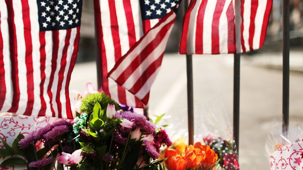 Flowers are left at a security gate near the scene of yesterday's bombing attack at the Boston Marathon on April 16, 2013 in Boston, Massachusetts. (Photo by Spencer Platt/Getty Images)