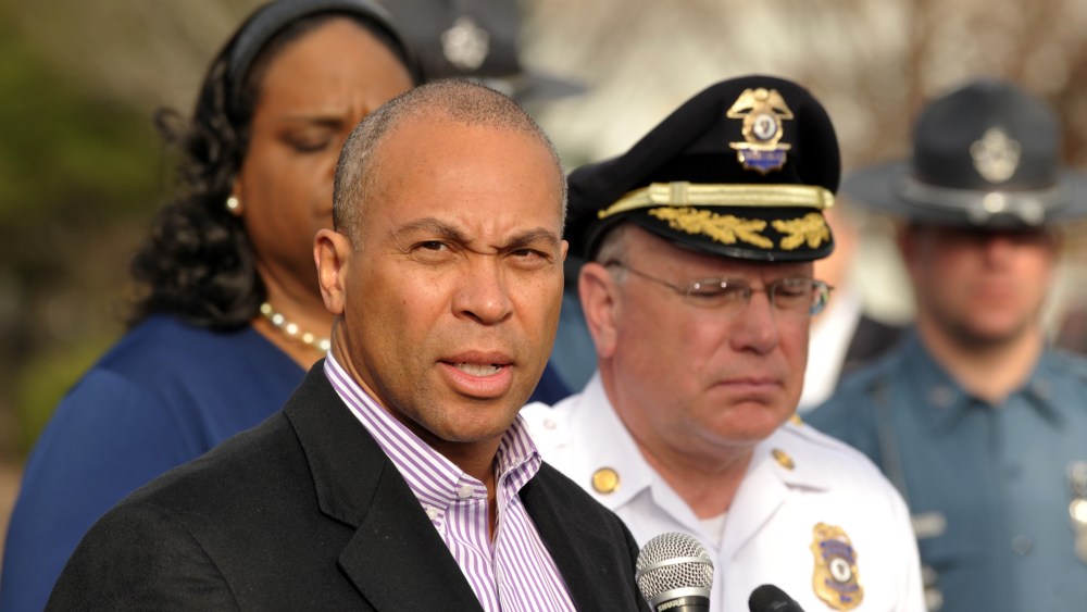 Massachusetts Governor Deval Patrick (L) speaks to the media at a shopping mall on the perimeter of a locked down area as a search for the second of two suspects wanted in the Boston Marathon bombings took place April 19, 2013, in Watertown, Mass. ...