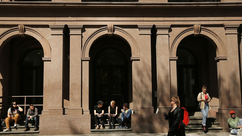 Students sit in front of Cooper Union for the Advancement of Science and Art, on April 24, 2013 in New York City.