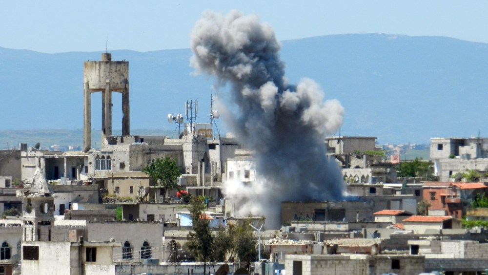 A picture taken on April 26, 2013 shows smoke rising after shelling in Houla in Syria's Homs province. The opposition National Coalition has accused the regime of using chemical weapons in the northern province of Aleppo, in Homs in central Syria, and...