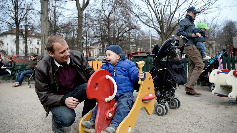 Swede Set Moklint plays with his kid Wilhelm during his paternity leave at Humlegarden park in Stockholm on April 24, 2013.