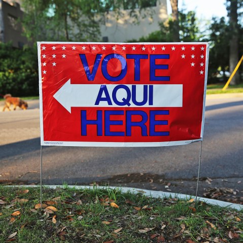 A bilingual sign stands outside a polling center at public library ahead of local elections on April 28, 2013 in Austin, Texas.