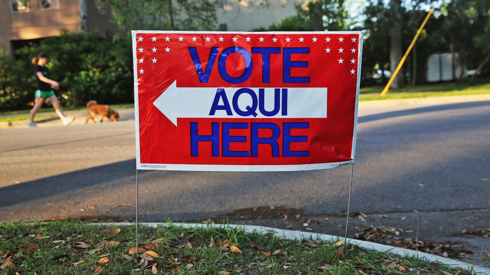 A bilingual sign stands outside a polling center at public library ahead of local elections on April 28, 2013 in Austin, Texas.