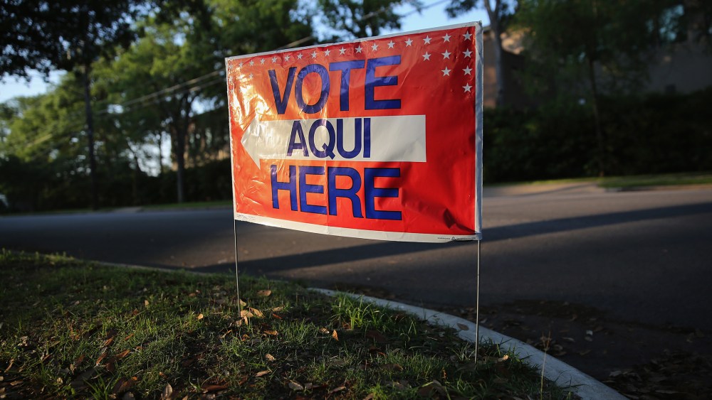 A sign stands outside a polling center at public library ahead of local elections on April 28, 2013 in Austin, Texas. (Photo by John Moore/Getty)