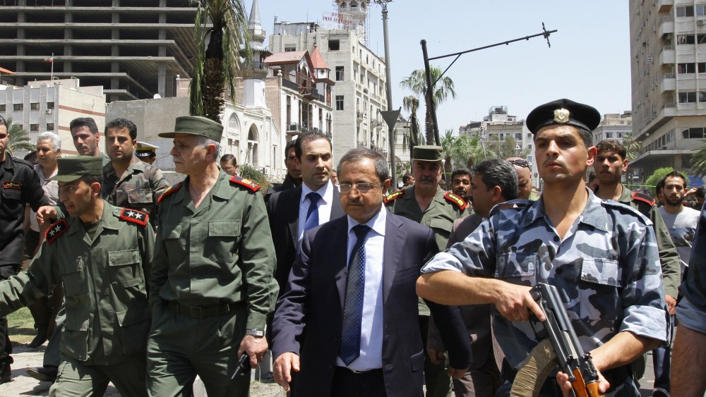 Syrian Interior Minister Mohammed al-Shaar (C) visits the site of a blast in the Marjeh district of Damascus on April 30 , 2013. A blast in the central Damascus district of Marjeh killed at least 14 people, Syrian state television reported, a day after...