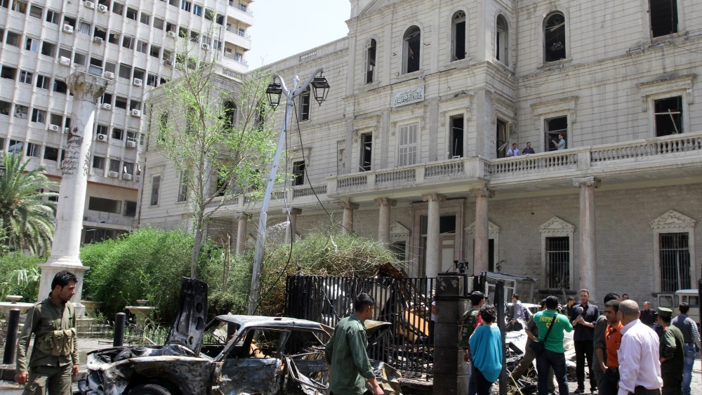 A destroyed car sits outside the Syrian Interior Ministry following a bomb blast in the Marjeh district of Damascus on April 30 , 2013. A blast in the central Damascus district of Marjeh killed at least 14 people, Syrian state television reported, a...