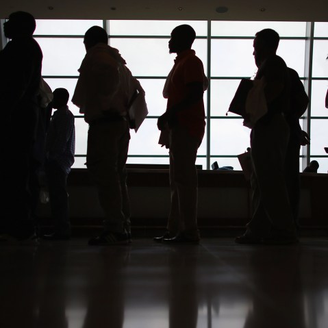 People looking for work stand in line to apply for a job during a job fair in Miami, Fla. (Photo by Joe Raedle/Getty)