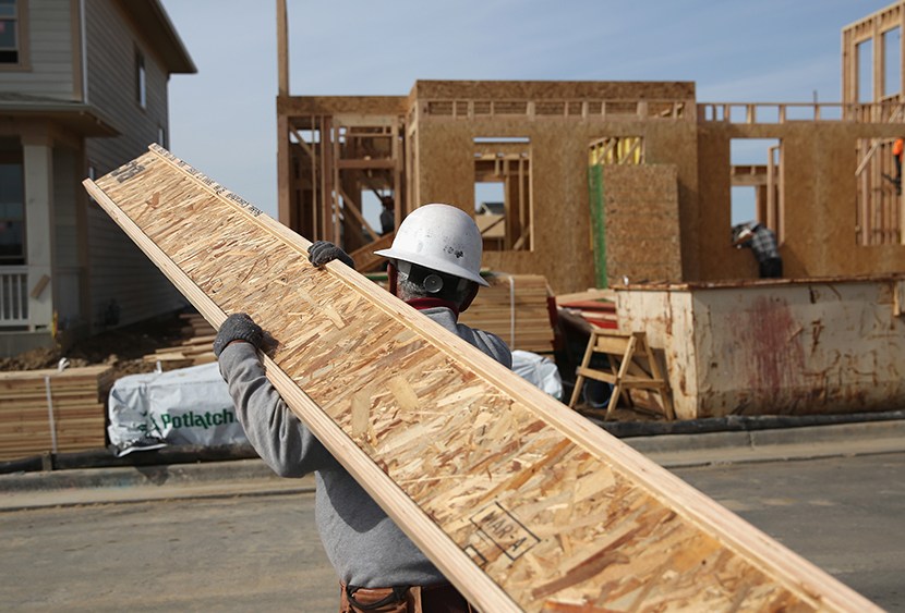 A laborer works at a housing development on May 3, 2013, in Denver, Colo.  (Photo by John Moore/Getty Images)