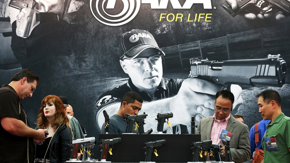 Attendees visit the Para booth at the 2013 NRA Annual Meeting and Exhibits in Houston, Texas, May 5, 2013.