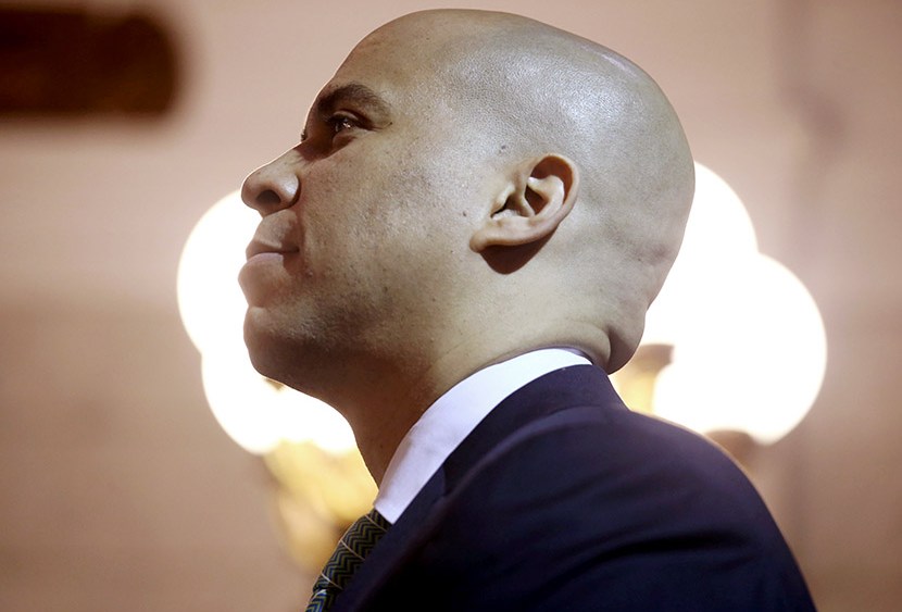 Newark Mayor Cory Booker stands for the presentation of the colors at the Newark City Hall on May 8, 2013 in Newark, New Jersey.   (Photo by John Moore/Getty Images)