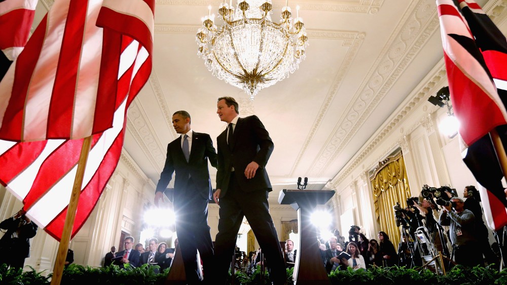 President Barack Obama (L) and British Prime Minister David Cameron leave the stage after holding a joint news conference in the East Room at the White House May 13, 2013 in Washington, D.C.