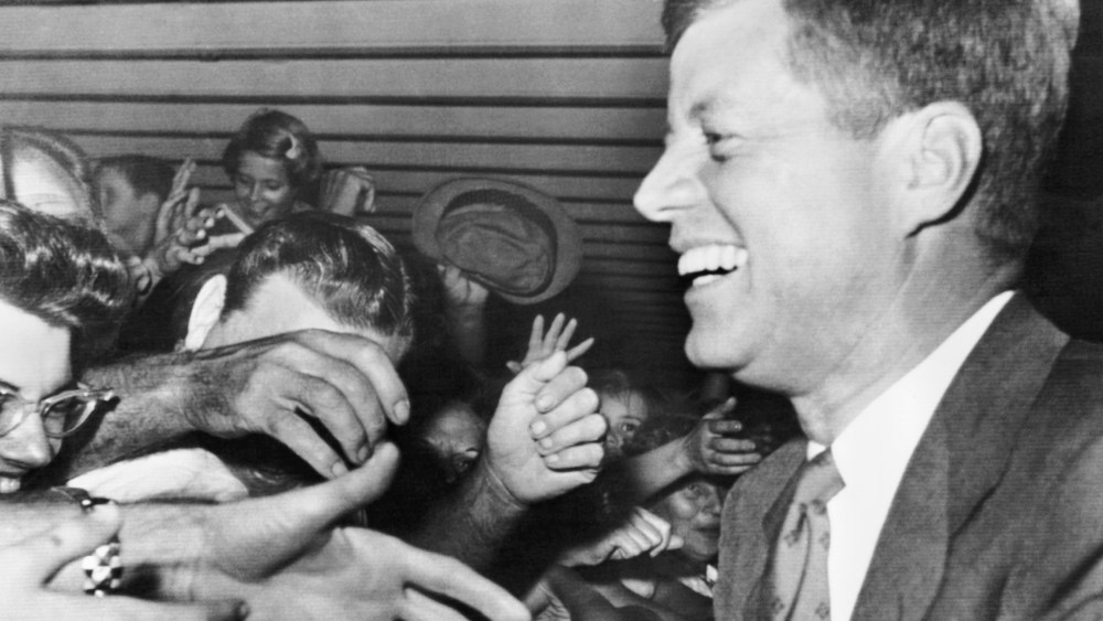 President-elect John F Kennedy smiles as hundreds of well-wishers greet him at the West Palm Beach Airport, Fla. Nov. 11, 1960.