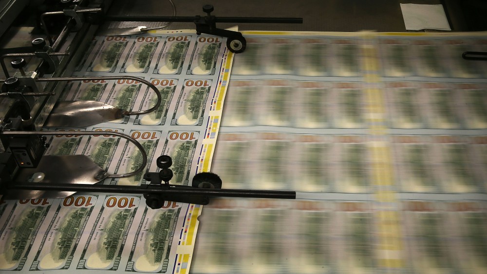 Newly redesigned $100 notes are printed at the Bureau of Engraving and Printing on May 20, 2013 in Washington, DC.