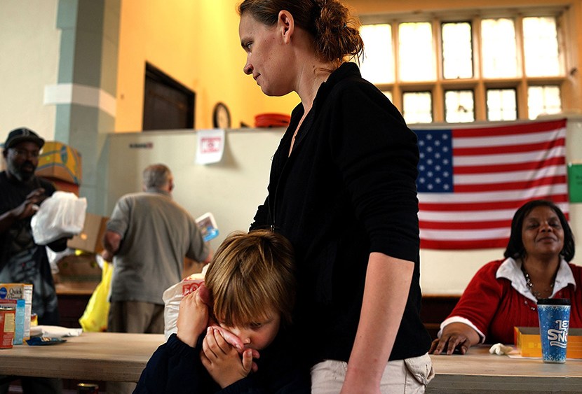 Mlissa Ruella and her son Randy, 3,  wait in line for groceries at the Greater Waterbury Interfaith Ministries on May 20, 2013 in Waterbury, Connecticut. Waterbury, once a thriving industrial city with one of the largest brass manufacturing bases in...