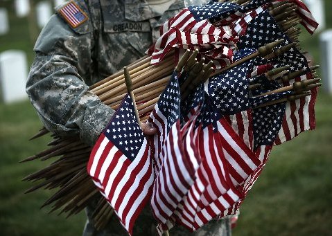 A member of the Fife and Drum Corps of the 3rd U.S. Infantry Regiment, "The Old Guard," participate in a "Flags-In" ceremony May 23, 2013 at Arlington National Cemetery in Arlington, Virginia. A small American flag was placed one foot in front of more...