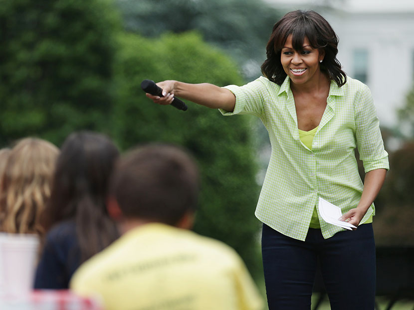 First lady Michelle Obama speaks to school children before they harvest the summer crop from the White House Kitchen Garden at the White House on May 28, 2013 in Washington, DC. (Photo by Chip Somodevilla/Getty Images)