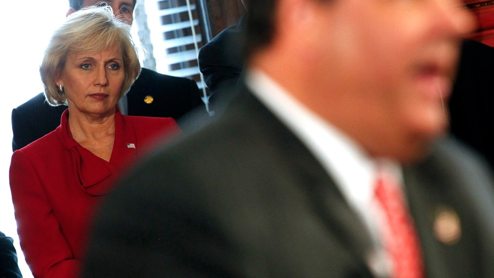 New Jersey Lt. Gov. Kim Guadagno looks on as New Jersey Gov. Chris Christie speaks in Trenton on June 4, 2013.
