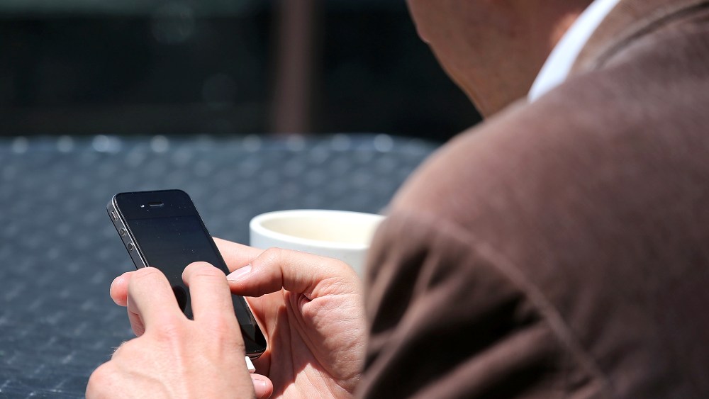 A man uses a smartphone in San Francisco, Calif., June 5, 2013.