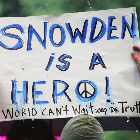 File photo: A supporter holds a sign at a small rally in support of National Security Administration (NSA) whistle-blower Edward Snowden June 10, 2013 in New York City.  (Photo by Mario Tama/Getty Images)