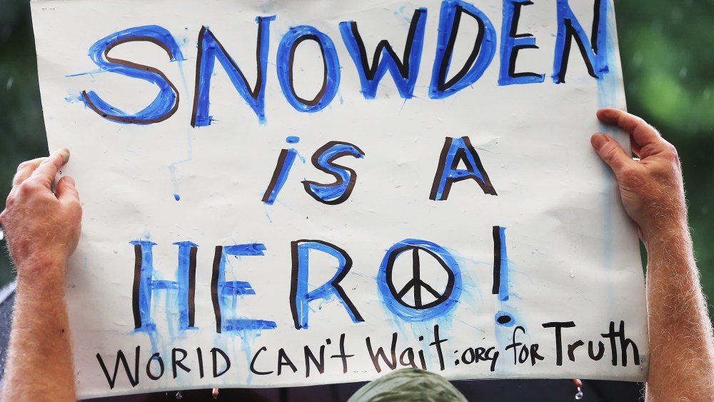 File photo: A supporter holds a sign at a small rally in support of National Security Administration (NSA) whistle-blower Edward Snowden June 10, 2013 in New York City.  (Photo by Mario Tama/Getty Images)